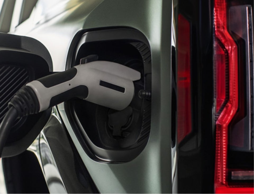 Close up of charging port with charger plugged in on a GMC Hummer EV SUV - Blake Fulenwider GMC in Eastland TX